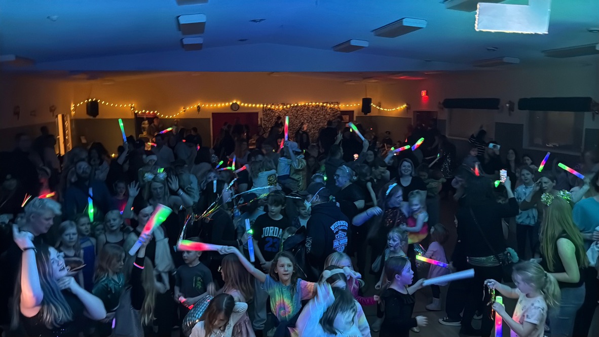 Crowd enjoying the dance party under blue lighting