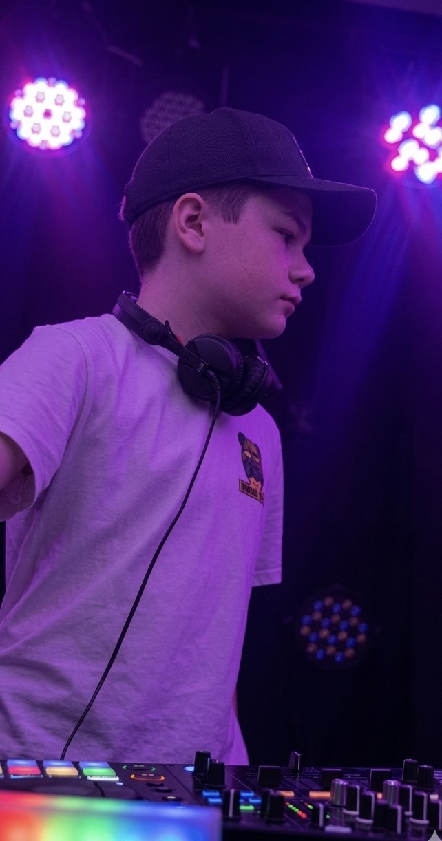 DJ Connor at his DJ booth under purple stage lights
